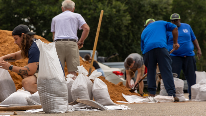 This image shows Florida residents filling sandbags ahead of likely Helene in the coming days. Potential Tropical Cyclone Nine was designated in the Caribbean on Monday, Sept. 23, 2024, and the system is expected to strengthen into a hurricane this week as it moves toward the U.S. Gulf Coast.