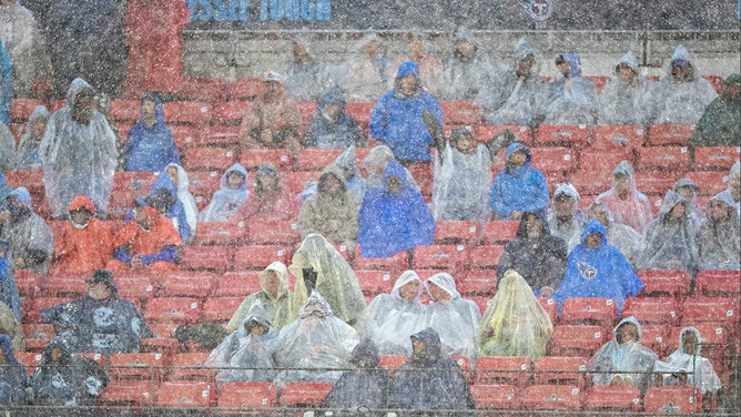 Fans standing in the rain during a game between the Tennessee Titans and the Houston Texans at Nissan Stadium on November 21, 2021 in Nashville, Tennessee.