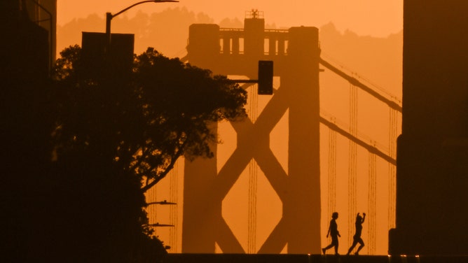 Sun rises over the Bay Bridge and California Street as called 'California Henge' in San Francisco, California, United States on September 3, 2024.