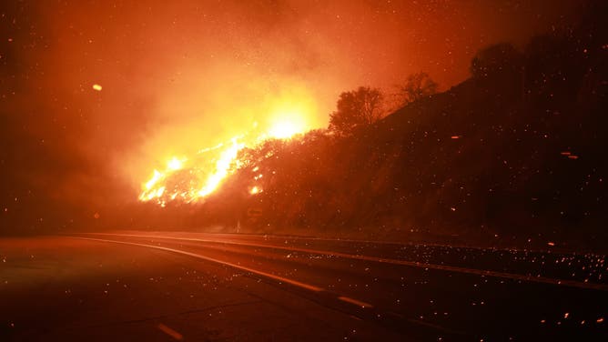 Embers fly through the air as Highway 330 is engulfed in flames from the Line Fire near Running Springs, California, on September 7, 2024. California Governor Gavin Newsom and San Bernardino County authorities declared a state of emergency on September 8. The Line Fire has burned more than 7,000 acres (2,800 hectares). (Photo by DAVID SWANSON / AFP) (Photo by DAVID SWANSON/AFP via Getty Images)