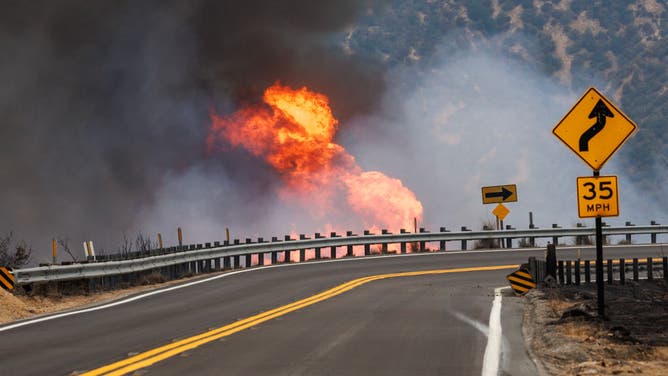 Erratic winds create small firestorms along the side of Highway 330 during the Line fire on September 8, 2024 in Highland, California.