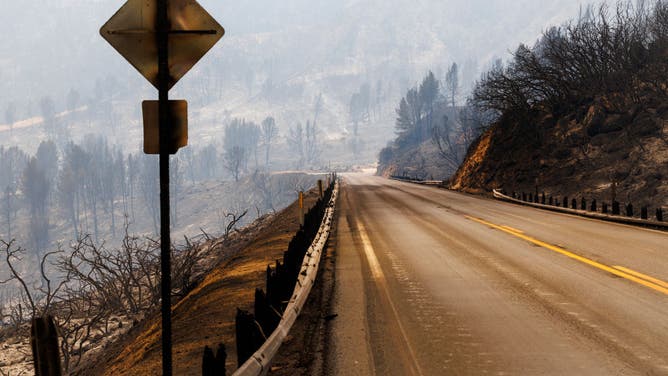 The terrain is burned on both sides of Highway 330 as smoke fills the air after the Line fire burned the mountain landscape on September 8, 2024 in Highland, California.