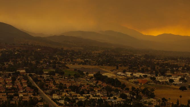 In an aerial view, a mix of rain and smoke from the nearby Line Fire creates a heavy stew of air pollution on September 8, 2024 over San Bernardino, California. 