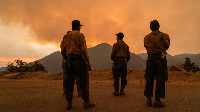 Firefighters with the Mill Creek Hotshots monitor fire activity during the Line Fire in Big Bear, California, US, on Monday, Sept. 9, 2024. A fast-growing wildfire forcing evacuations in Southern California shows the danger the state now faces, as record-smashing heat waves dry out the landscape just as the Santa Ana wind season is due to begin. Photographer: Kyle Grillot/Bloomberg via Getty Images