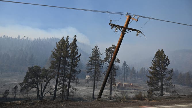 Downed electric power lines are seen in the Bridge Fire in Wrightwood, California on September 11, 2024.