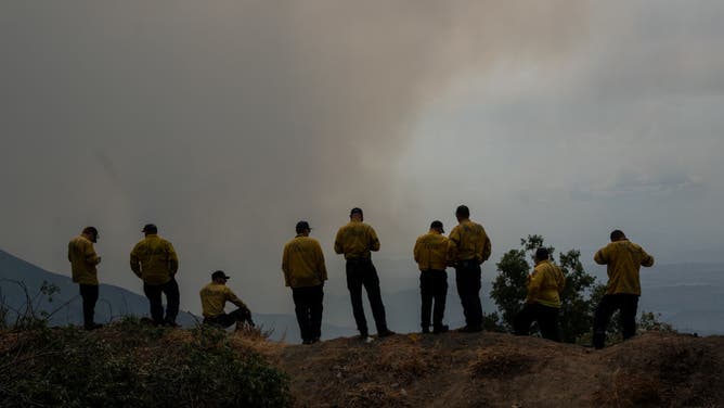 Firefighters react as the Line Fire grows on September 8, 2024 in San Bernardino, California.