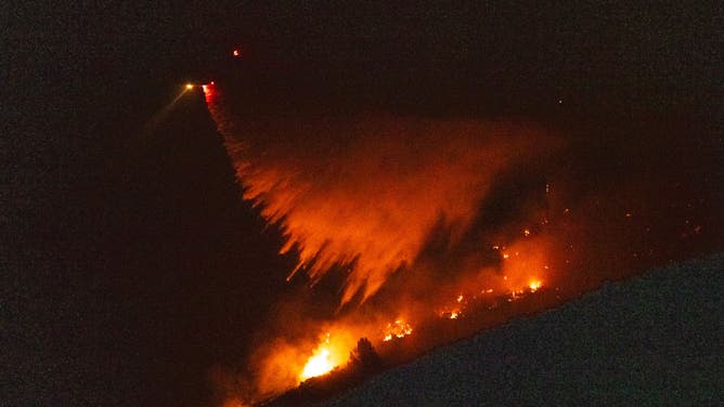 A water-dropping helicopter battles the Line Fire growing on September 8, 2024 in San Bernardino, California.