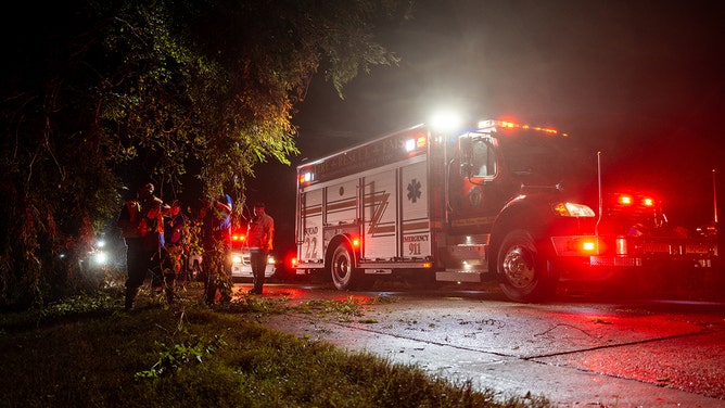 First responders from the Coteau Fire District clear downed branches after Hurricane Francine swept through the area in Houma, Louisiana on September 11, 2024.