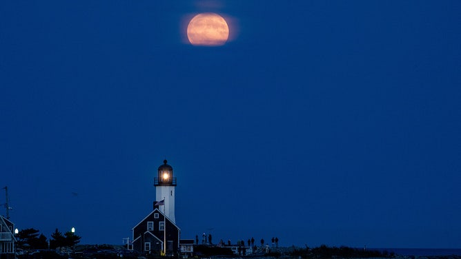 The harvest moon, a full supermoon, rises over Scituate Light (the Scituate Lighthouse) in Scituate, Massachusetts, United States on September 17, 2024.