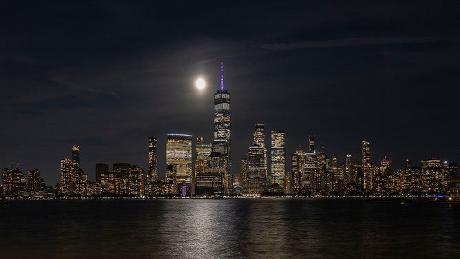 The full Harvest Supermoon will rise behind the Lower Manhattan skyline and One World Trade Center in New York City on September 17, 2024, as seen from Jersey City, New Jersey.