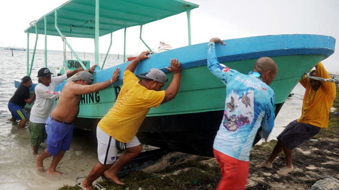 People secure their boats ahead of the arrival of impending Hurricane Helene in Cancun, Quintana Roo state, Mexico, September 24, 2024. (Photo by Elizabeth Ruiz / AFP) (Photo by ELIZABETH RUIZ/AFP via Getty Images)