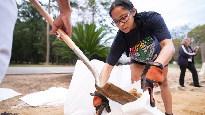 TALLAHASSEE, FLORIDA - SEPTEMBER 25: Kyley Weems gathers sand in preparation for possible flooding on September 25, 2024 in Tallahassee, Florida. Forecasts predict that Tropical Storm Helene will strengthen to a hurricane and make landfall along Florida's Gulf Coast on Thursday. (Photo by Sean Rayford/Getty Images)