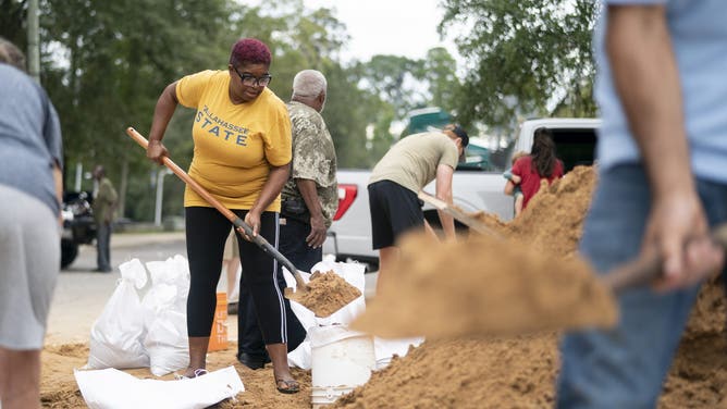 TALLAHASSEE, FLORIDA - SEPTEMBER 25: Tallahassee State professor Pamela Andrews bags sand in preparation for possible flooding as Tropical Storm Helene heads toward the state's Gulf Coast on September 25, 2024 in Tallahassee, Florida. Currently, Tropical Storm Helene is forecast to become a major hurricane, bringing the potential for deadly storm surges, flooding rain, and destructive hurricane-force winds along parts of the Florida West Coast. Helene is expected to make landfall in Florida on Thursday. (Photo by Sean Rayford/Getty Images)