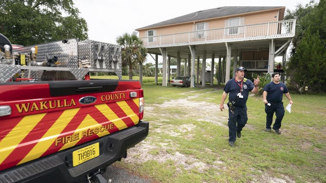 PANACEA, FLORIDA - SEPTEMBER 25: Wakulla County firefighters go door-to-door to take note of which residents plan to stay in their homes during Hurricane Helene on September 25, 2024 at Ochlockonee Point near Panacea, Florida. Hurricane Helene is forecast to become a major storm, bringing the potential for deadly storm surges, flooding rain, and destructive hurricane-force winds along parts of the Florida West Coast. Helene is expected to make landfall in Florida on Thursday. (Photo by Sean Rayford/Getty Images)