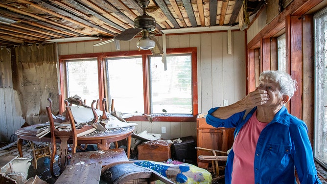 Bobbi Pattison responds to damage at her home in Steinhatchee, Florida, after Hurricane Helene passed through on Friday, September 27, 2024.