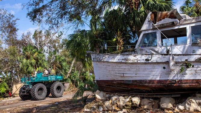 A team patrols the streets of Steinhatchee, Florida in an all-terrain vehicle after Hurricane Helene passed through on Friday, September 27, 2024.