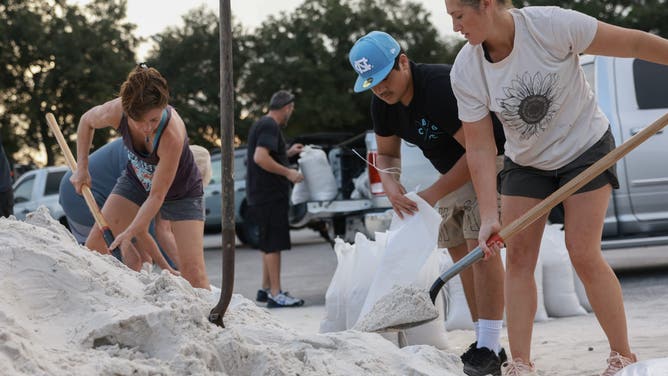 PINELLAS PARK, FLORIDA - SEPTEMBER 25: Residents fill sandbags at Helen Howarth Park ahead of the possible arrival of Hurricane Helene on September 25, 2024 in Pinellas Park, Florida. Currently, Tropical Storm Helene is forecast to become a major hurricane, bringing the potential for deadly storm surges, flooding rain, and destructive hurricane-force winds along parts of the Florida West Coast. Helene is expected to make landfall in Florida on Thursday. (Photo by Joe Raedle/Getty Images)