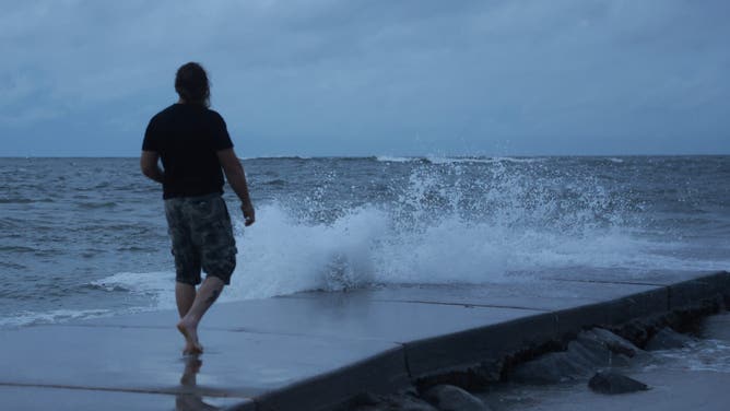 ST PETE BEACH, FLORIDA – SEPTEMBER 26: Neil (who did not want to provide his last name) visits the beach as Hurricane Helene rages offshore in St. Pete Beach, Florida on September 26, 2024. Helene is expected to become a major hurricane later today, bringing the potential for deadly storm surge, flooding rain and devastating hurricane force winds along parts of Florida's west coast. (Photo by Joe Raedle/Getty Images)