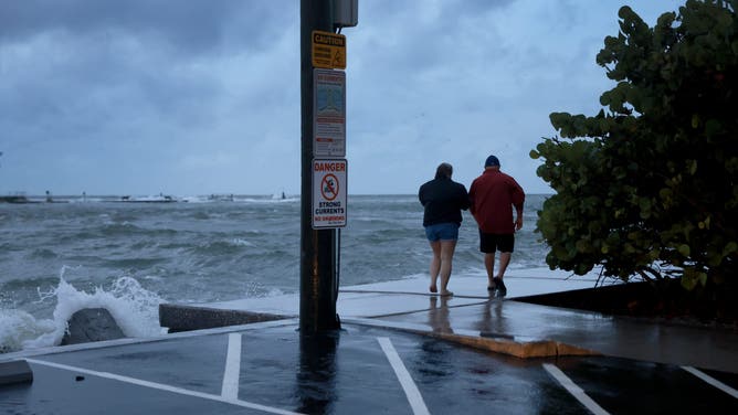 ST PETE BEACH, FLORIDA - SEPTEMBER 26: People visit the beach as Hurricane Helene churns offshore on September 26, 2024 in St. Pete Beach, Florida. Later today, Helene is forecast to become a major hurricane, bringing the potential for deadly storm surges, flooding rain, and destructive hurricane-force winds along parts of the Florida West Coast. (Photo by Joe Raedle/Getty Images)