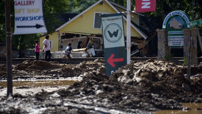 People view damage in the aftermath of Hurricane Helene on September 29, 2024 in Old Fort, North Carolina.