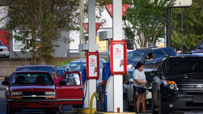 People line up to fill their gas tanks at an Exxon station off Highway 40 on September 29, 2024 in Marion, North Carolina.