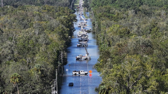 In this aerial view, electrical crews work on the lines after Hurricane Helene passed offshore in Crystal River, Florida, on September 27, 2024.