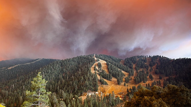 Smoke billows from Bridge Fire in the distance.