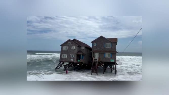 A house collapses on the beach in Rodanthe Tuesday