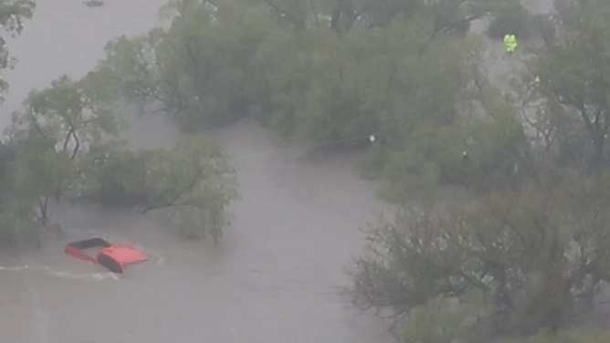 The red truck submerged in floodwater.