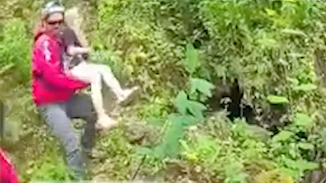 A first responder lifts the girl onto a boat.