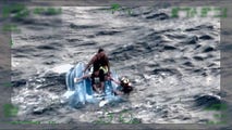 Watch: US Coast Guard saves father and sons clinging to capsized boat in Hawaii