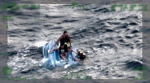 Watch: US Coast Guard saves father and sons clinging to capsized boat in Hawaii