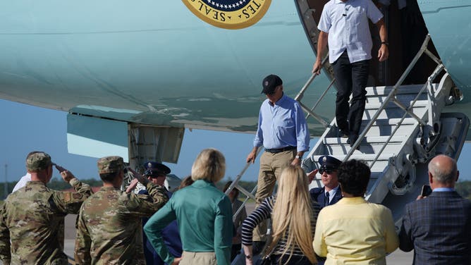 US President Joe Biden (C) arrives at MacDill Air Force Base in Tampa, Florida, on October 13, 2024, where he will survey areas damaged by Hurricane Milton. The death toll from Milton rose to at least 16, officials in Florida said October 11, and millions were still without power as residents began the painful process of piecing their lives back together. (Photo by Bonnie CASH / AFP) (Photo by BONNIE CASH/AFP via Getty Images)