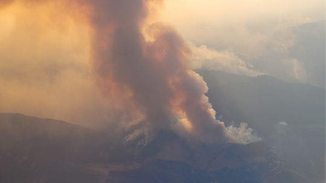 This image shows thick plumes of smoke rising into the air above Wyomings Bighorn National Forest as the Elk Fire continues to rage.