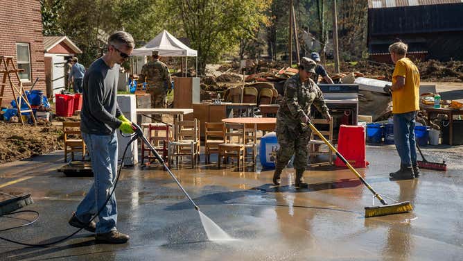 North Carolina National Guard Soldier Diana Campuzano assigned to Bravo 5th Battalion, 113th Field Artillery Regiment sweeps mud and provides help with hurricane relief efforts at Cove Creek Baptist Church in Watauga County October 12, 2024.