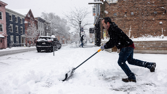 FILE - A resident shovels snow during a storm in Hudson, New York, US, on Sunday, Jan. 7, 2024. Hundreds of flights have been grounded across the US from a pair of winter storms that left more than a foot of snow in New York's Hudson Valley and sparked blizzard warnings across the Great Plains. Photographer: Angus Mordant/Bloomberg via Getty Images