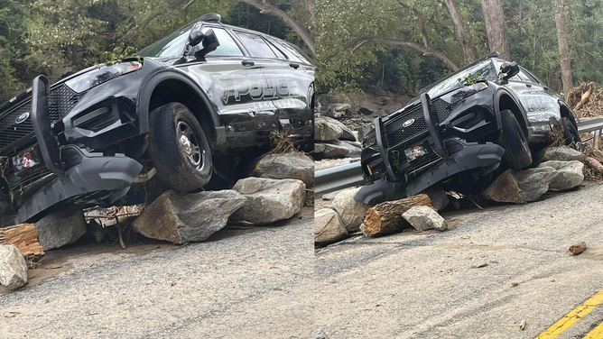 A Lake Lure police cruiser on boulders moved by powerful flood waters.