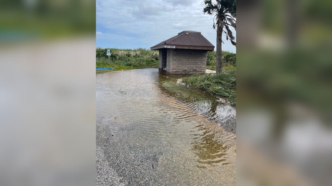 Flooding at a comfort station in a parking area within Canaveral National Seashore.