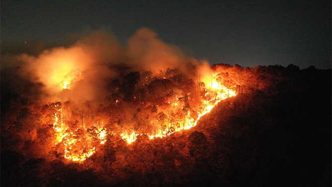 This dramatic image shows intense flames scorching the landscape at Lamentation Mountain in Berlin, Connecticut on Monday, October 21, 2024.