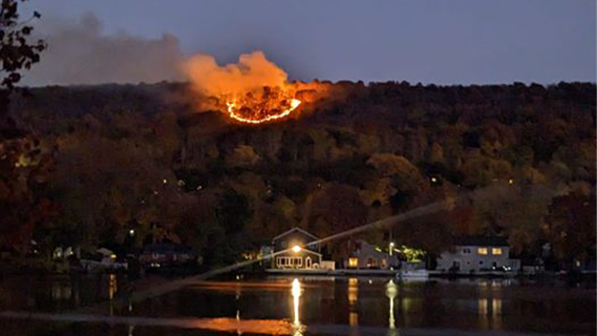 This photo shows a large fire burning on Lamentation Mountain in Berlin, Connecticut on Monday, October 21, 2024.