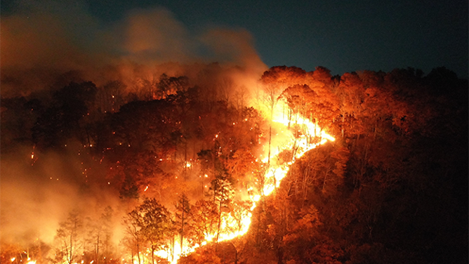 This dramatic image shows intense flames scorching the landscape at Lamentation Mountain in Berlin, Connecticut on Monday, October 21, 2024.