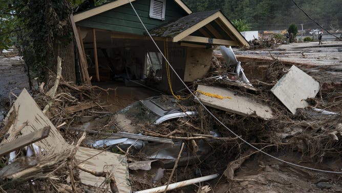 The remains of a house are seen in Lake Lure, North Carolina, on October 2, 2024, after Hurricane Helene. The death toll from powerful Storm Helene that devastated the southeastern United States has risen to more than 155, authorities said Oct. 1, as President Joe Biden and Vice President Kamala Harris surveyed the damage. (Photo by Allison Joyce / AFP) (Photo by ALLISON JOYCE/AFP via Getty Images)