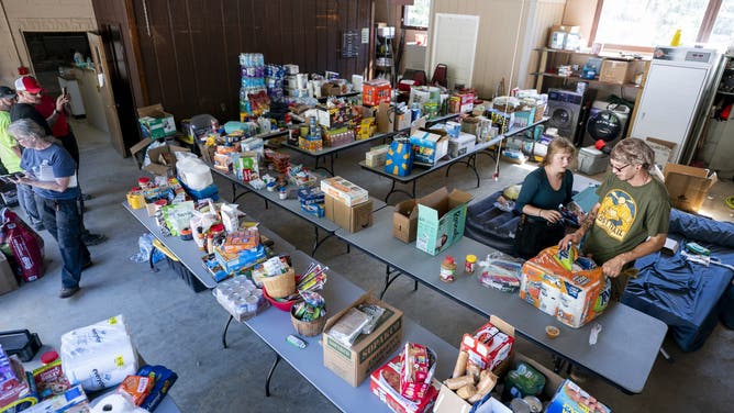 BAT CAVE, NORTH CAROLINA - OCTOBER 2: People organize food for residents at the Bat Cave Fire Department in the aftermath of Hurricane Helene on October 1, 2024 near Bat Cave, North Carolina. The death toll has topped 180 people across the southeastern U.S. due to the storm, according to published reports, which made landfall as a category 4 storm on Thursday. Millions are without power and the federal government has declared major disasters in areas of North Carolina, Florida, South Carolina, Tennessee, Georgia, Virginia and Alabama, freeing up federal emergency management money and resources for those states, according to the reports. (Photo by Sean Rayford/Getty Images)