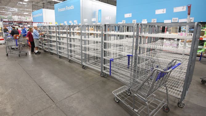 Customers check mostly empty bread shelves at a shopping warehouse in Kissimmee, Florida on October 6, 2024.