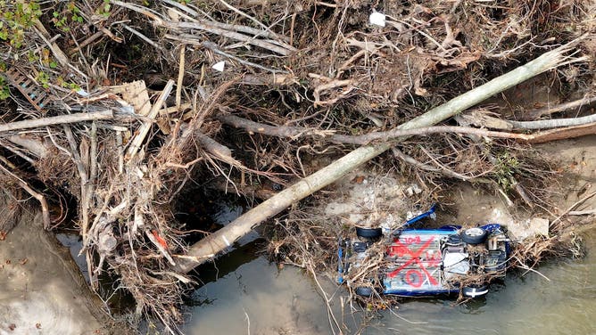 An aerial view of a car and trees destroyed by flooding wrought by Hurricane Helene on October 3, 2024 in Black Mountain, North Carolina. 