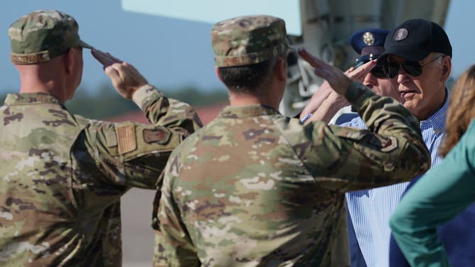 US President Joe Biden (R) salutes as he arrives at MacDill Air Force Base in Tampa, Florida, on October 13, 2024, where he will survey areas damaged by Hurricane Milton. The death toll from Milton rose to at least 16, officials in Florida said October 11, and millions were still without power as residents began the painful process of piecing their lives back together. (Photo by Bonnie CASH / AFP) (Photo by BONNIE CASH/AFP via Getty Images)