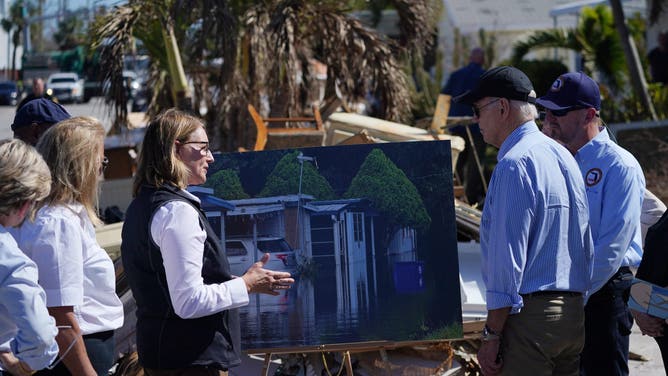 US President Joe Biden (2nd R) receives an operational briefing from FEMA Administrator Deanne Criswell (3rd L) on the aftermath of Hurricane Milton in St. Pete Beach, Florida, on October 13, 2024. The death toll from Milton rose to at least 16, officials in Florida said October 11, and millions were still without power as residents began the painful process of piecing their lives back together. (Photo by Bonnie CASH / AFP) (Photo by BONNIE CASH/AFP via Getty Images)