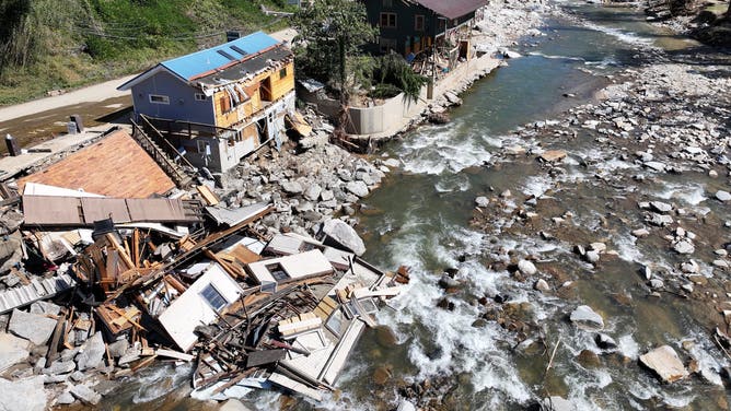 Destroyed buildings in Bat Cave, North Carolina. One of the buildings has crumbled into the river below.