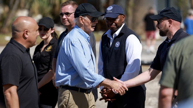 ST PETE BEACH, FLORIDA - OCTOBER 13: U.S. President Joe Biden greets people during a tour of the damage caused by Hurricane Milton on October 13, 2024 in St Pete Beach, Florida. Biden visited the area as it deals with back-to-back hurricanes that have caused extensive damage. (Photo by Joe Raedle/Getty Images)