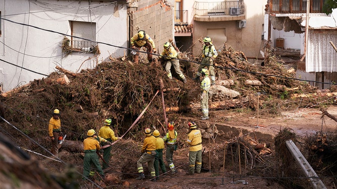 Rescue workers clear debris after heavy rains hit the region on October 30, 2024, in Letur, Albacete province, Spain.